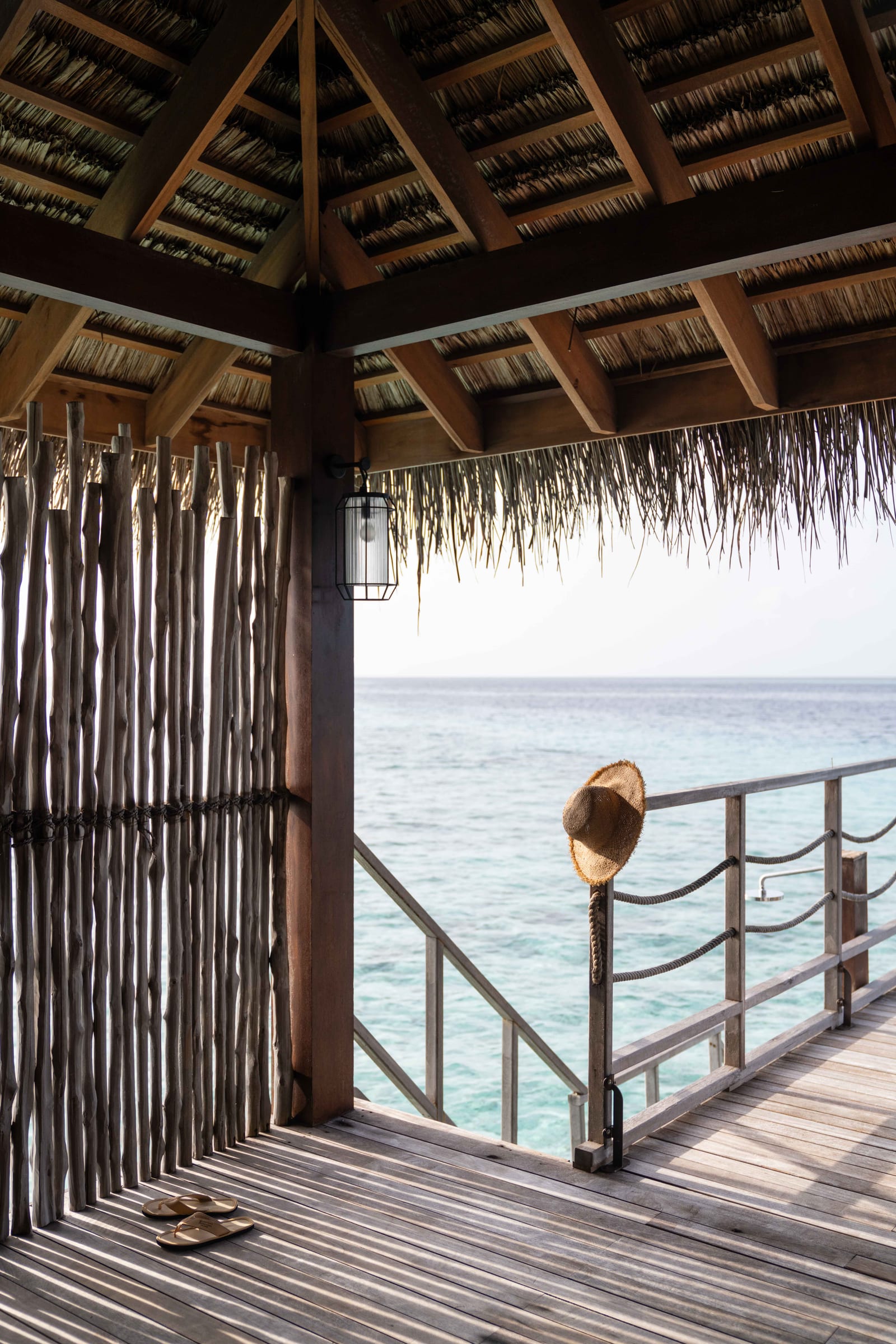 Constance Moofushi water villa above turquoise lagoon waters