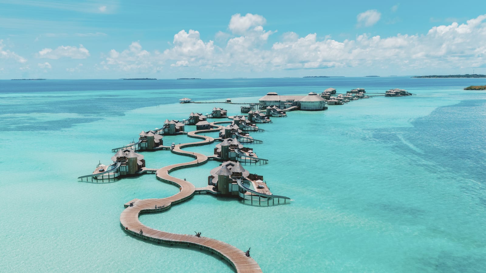 Aerial view of the North Jetty at Soneva Jani, with overwater villas reaching into the Noonu Atoll lagoon.