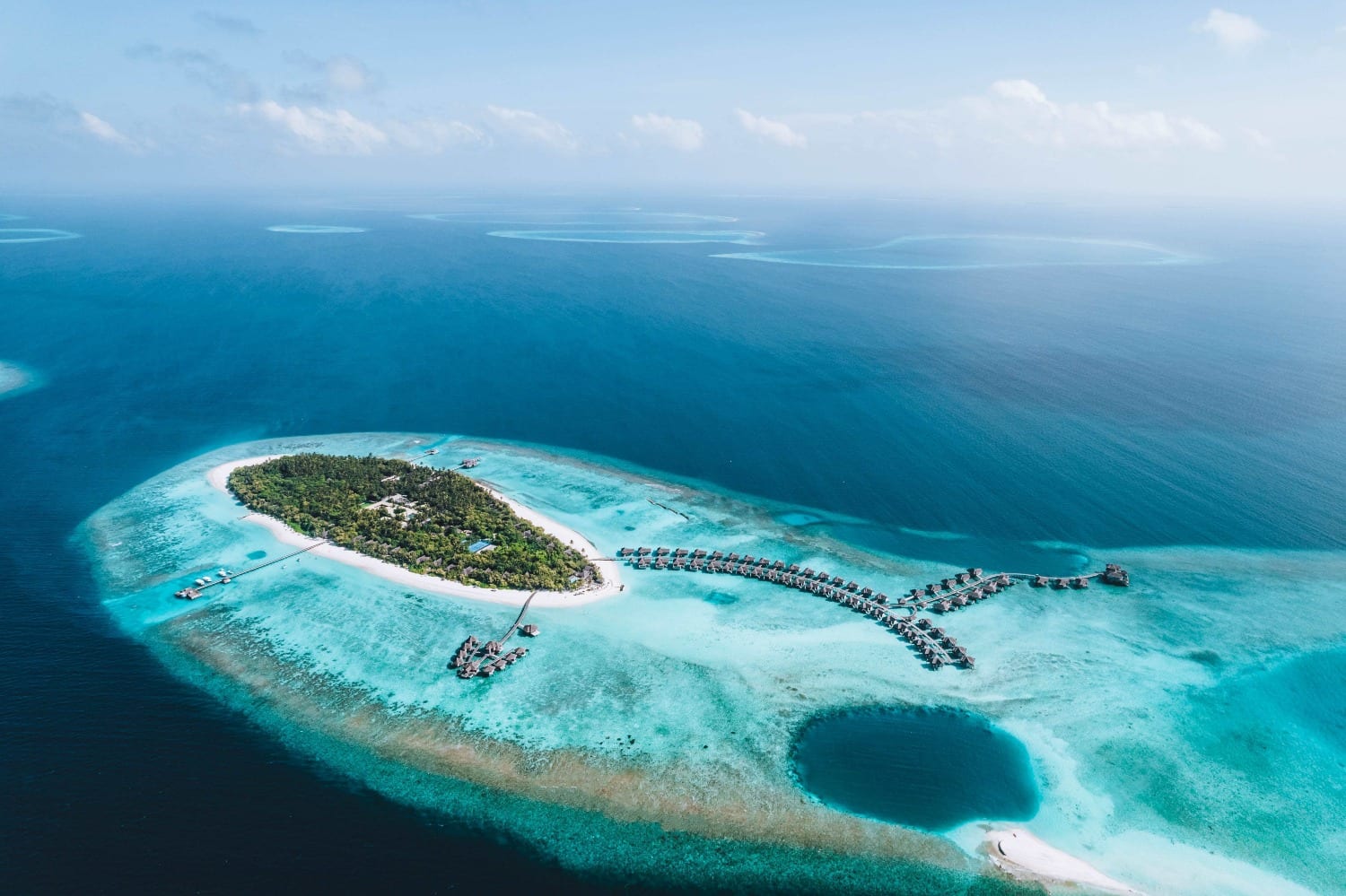 Aerial view of Vakkaru Maldives' island and overwater villas in Baa Atoll